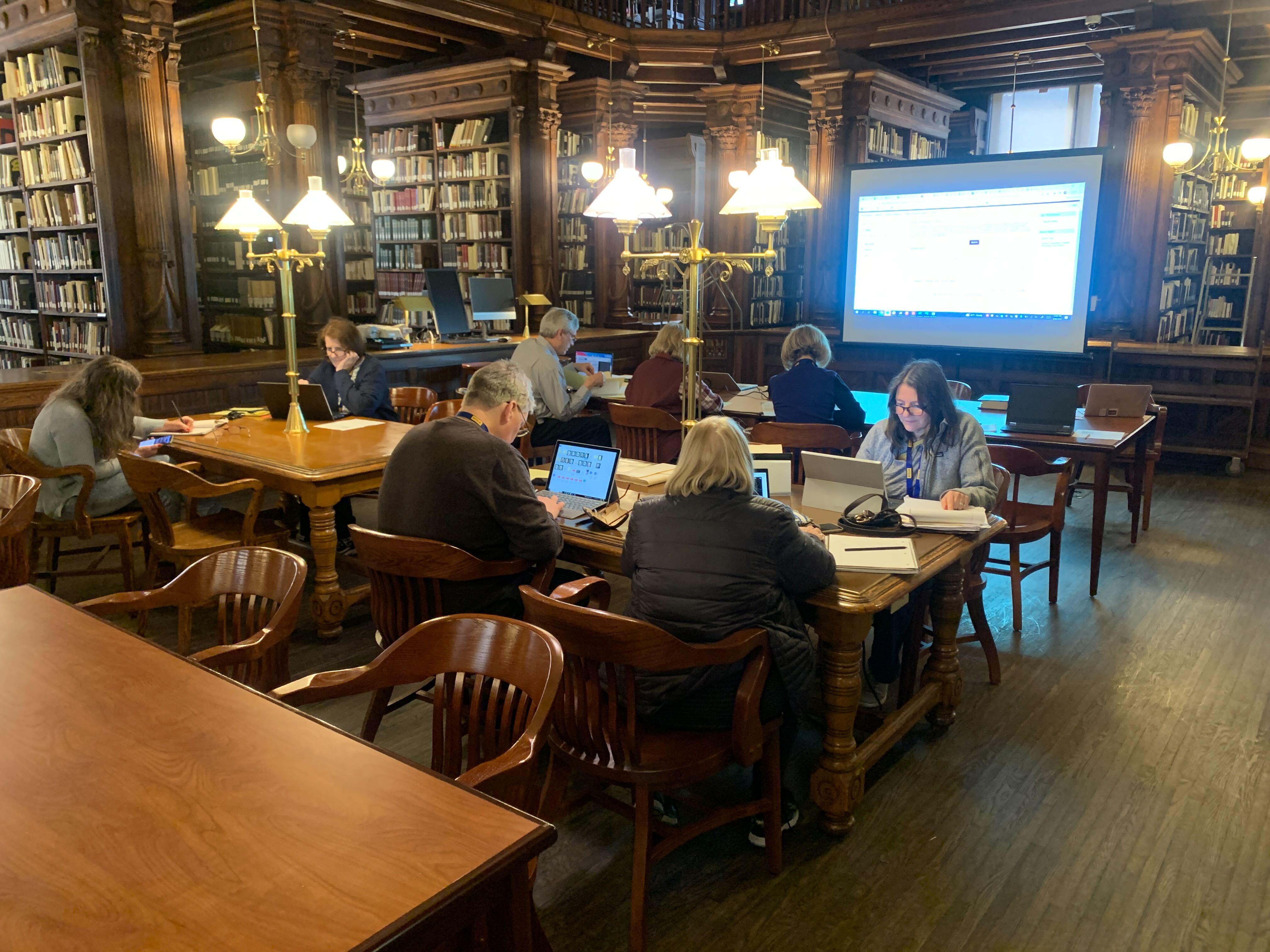 Researchers working in a library
