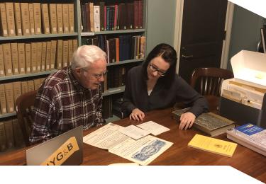 A professional genealogist consults with a client